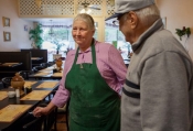 Mack Wolford’s mother, Snook, chats with a customer at the cafe where she works with Mack’s wife, Fran, Bramwell, West Virginia, September 2013. 